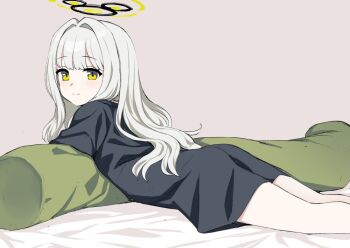 1girl ass black_shirt blue_archive blush body_pillow green_eyes grey_background hair_intakes halo hare_(blue_archive) hare_(pajamas)_(blue_archive) kumadano long_hair looking_back lying naked_shirt on_stomach oversized_clothes oversized_shirt pillow shirt solo t-shirt white_hair