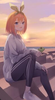 1girl :d backlighting black_pants blue_eyes blush casual cellphone commentary earphones eyelashes go-toubun_no_hanayome green_ribbon grey_sweater hair_between_eyes hair_ribbon heart highres holding holding_phone knees_up long_sleeves looking_at_viewer medium_hair nakano_yotsuba ocean open_mouth orange_hair orange_sky outdoors pants phone profnote ribbon sitting sky sleeves_past_wrists smartphone smile solo spoken_heart sunset sweater