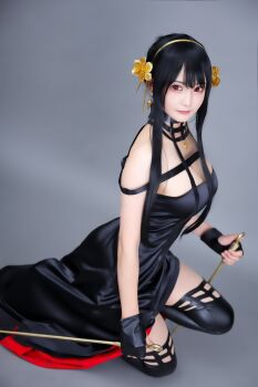 1girl bare_shoulders black_dress black_hair breasts cleavage closed_mouth cosplay cosplay_photo dress earrings female_focus flower hair_flower hair_ornament hairband highres jewelry kipi_84 large_breasts looking_at_viewer photo_(medium) real_life red_eyes sitting sleeveless sleeveless_dress smile solo spy_x_family wariza yor_briar yor_briar_(cosplay)