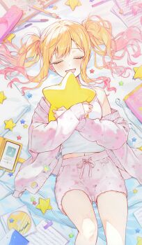1girl absurdres blonde_hair blush camisole cardigan cd closed_eyes earphones feet_out_of_frame gradient_hair highres hugging_object lying mechanical_pencil midriff_peek moro_(from_m0r0) multicolored_hair navel on_back open_mouth pencil pencil_case pillow pillow_hug pink_cardigan pink_hair pink_shorts project_sekai sheet_music shorts sidelocks smartphone_case smile solo star-shaped_pillow swept_bangs tenma_saki twintails white_camisole