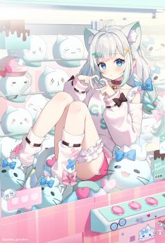 1girl animal_ear_fluff animal_ears asymmetrical_legwear ayamy bell blue_bow blue_eyes blue_hair bow braid cat_ears cat_girl cat_tail collar commentary dolphin_shorts english_commentary extra_ears four-finger_heart_hands frilled_straps frilled_thigh_strap gradient_hair green_hair hair_bow hair_ornament hairclip heart heart_hands highres in_crane_game indie_virtual_youtuber knees_up long_hair looking_at_viewer mint_fantome mint_fantome_(otaku) multicolored_hair neck_bell off-shoulder_sweater off_shoulder official_alternate_costume official_alternate_hairstyle official_artist_extra pink_bow pink_collar pink_hair pink_shorts pointy_ears shorts sitting slippers socks solo streaked_hair sweater tail thigh_strap twin_braids uneven_legwear virtual_youtuber white_hair white_socks wisps_(mint_fantome) x_hair_ornament