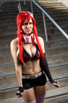 1girl asymmetrical_gloves beccadex belt bikini bikini_top_only breasts cleavage cosplay_photo elbow_gloves fingerless_gloves flame_print gloves hair_ornament hair_stick high_ponytail large_breasts leather_shorts long_sidelocks navel no_shirt nose_piercing nose_ring photo_(medium) piercing pink_scarf ponytail pout real_life red_hair scarf short_shorts shorts sidelocks single_elbow_glove skull_hair_ornament solo stairs stairwell studded_belt sunglasses tengen_toppa_gurren_lagann uneven_gloves yoko_littner yoko_littner_(cosplay)