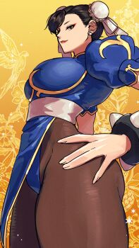 1girl blue_dress bracelet breasts brown_eyes brown_hair brown_pants capcom china_dress chinese_clothes chun-li closed_mouth commentary dress earrings eyeliner from_side hand_on_own_hip hashtag-only_commentary highres jewelry large_breasts looking_at_viewer makeup pants puffy_short_sleeves puffy_sleeves red_eyeliner ryo_yo_shi short_sleeves smile solo spiked_bracelet spikes street_fighter stud_earrings