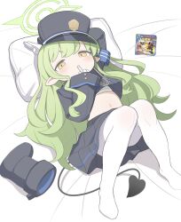 Rule 34 | 1girl, atat250, bed sheet, black footwear, black hat, black jacket, black skirt, black tail, blue archive, blush, boots, demon tail, green hair, green halo, halo, hat, highlander sidelocks conductor (blue archive), highres, jacket, long hair, long sleeves, pantyhose, peaked cap, pillow, pleated skirt, pointy ears, sidelocks, skirt, solo, tail, unworn boots, white pantyhose, yellow eyes