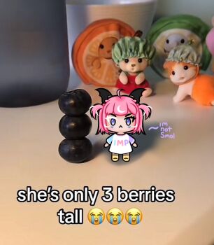 Rule 34 | 1girl, :<, ahoge, blueberry, camila (vtuber), chibi, chibi only, closed mouth, clothes writing, colored eyelashes, commentary, crying emoji, directrix, emoji, english commentary, english text, facial mark, food, fruit, full body, head wings, indie virtual youtuber, mini person, minigirl, mismatched eyebrows, mismatched eyelashes, multicolored hair, photo background, pink hair, purple eyes, shirt, solo, streaked hair, triangle, triangle facial mark, two side up, virtual youtuber, white hair, white shirt, wings