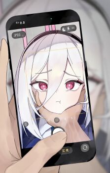 1girl 1other :t absurdres black_hairband blue_archive blurry blurry_background blush bright_pupils cellphone closed_mouth commentary double-parted_bangs film_grain furrowed_brow hair_between_eyes hairband halo hand_on_another's_chin highres holding holding_phone kei_(blue_archive) kei_(new_body)_(blue_archive) long_hair_between_eyes looking_at_viewer odod1228 phone pink_halo portrait pout pov pov_hands red_eyes ringed_eyes smartphone solo_focus taking_picture tsurime viewfinder white_hair white_pupils