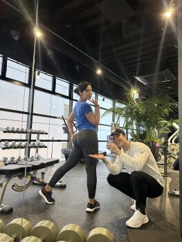 1boy 1girl asian ass bare_shoulders black_hair breasts fingernails gym hair_bun highres huge_ass japanese_(nationality) long_hair looking_at_viewer looking_back model panties pants photo_(medium) ponytail ririkana selfie shirt solo standing thighs underwear v yoga_pants