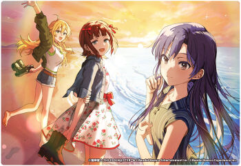 3girls amami_haruka armpits arms_behind_back bare_legs beach blonde_hair blue_hair breasts brown_eyes brown_hair collarbone collared_shirt dress floral_print footprints green_eyes holding holding_shoes holding_unworn_clothes hoshii_miki idolmaster idolmaster_tours kisaragi_chihaya long_hair looking_at_viewer medium_breasts medium_hair multiple_girls open_mouth shirt shoes shorts sleeveless small_breasts smile sparkle straight_hair sunset unworn_shoes wata_(attaka_towel) waving