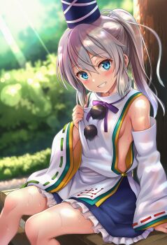 1girl blue_eyes blue_hat blue_skirt blush breasts commentary_request detached_sleeves frilled_skirt frills grey_hair hair_between_eyes hat highres japanese_clothes kariginu light_rays long_hair looking_at_viewer medium_breasts mononobe_no_futo okasa_re_taii outdoors pom_pom_(clothes) ponytail ribbon-trimmed_sleeves ribbon_trim sideboob sitting skirt smile solo sweat tate_eboshi touhou