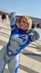 1girl animated ass audible_music blonde_hair blue_bodysuit bodysuit breasts copyright_name cosplay elizabeth_rage fantastic_four highres large_breasts long_hair marvel marvel_rivals multicolored_bodysuit real_life sound sue_storm sue_storm_(cosplay) superhero_costume two-tone_bodysuit video white_bodysuit