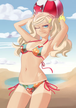1girl ball beach beachball bikini blonde_hair blue_eyes blysill breasts breasts_apart closed_mouth commentary english_commentary floral_print floral_print_bikini highres holding holding_ball holding_beachball long_hair looking_at_viewer navel one_eye_closed persona persona_5 print_bikini solo swimsuit takamaki_ann tan tanline