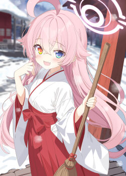 1girl :d ahoge alternate_costume aruka_(alka_p1) blue_archive blue_eyes blush broom commentary_request day from_side hair_between_eyes hakama hakama_skirt halo hands_up heterochromia highres holding holding_broom hoshino_(blue_archive) japanese_clothes kosode long_hair long_sleeves looking_at_viewer looking_to_the_side miko open_mouth outdoors pink_hair pink_halo red_hakama skirt smile snow solo standing very_long_hair yellow_eyes