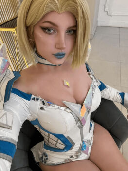 1girl blonde_hair blue_leotard blue_lips breasts cleavage closed_mouth cosplay cosplay_photo diamond_(gemstone) earrings emma_frost emma_frost_(cosplay) emma_frost_(marvel_rivals) female_focus jewelry large_breasts leotard lipstick looking_at_viewer makeup marvel marvel_rivals multicolored_leotard photo_(medium) real_life short_hair sitting solo superhero_costume thighs ulichan white_leotard x-men