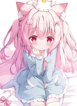 1girl animal animal_ear_fluff animal_ears animal_on_head between_legs blue_dress blush bow candy cat cat_ears cat_on_head crown dress food frilled_dress frills hair_ornament hand_between_legs highres long_hair no_shoes on_head original pillow pink_bow pink_eyes pink_hair red_eyes sitting solo tail thighhighs twitter_username wariza white_thighhighs yuduki_pdx