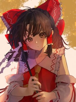 1girl absurdres ascot bow brown_eyes brown_hair closed_mouth commentary detached_sleeves eneshi frilled_bow frilled_hair_tubes frills gohei hair_bow hair_tubes hakurei_reimu highres holding holding_gohei long_hair looking_at_viewer red_bow ribbon-trimmed_sleeves ribbon_trim signature solo touhou yellow_ascot