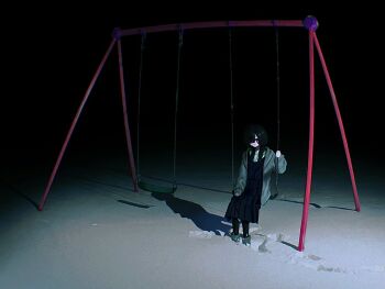 1girl black_dress black_hair black_pantyhose dress footprints grey_jacket hair_over_one_eye jacket long_hair night on_swing original outdoors pantyhose red_eyes sanada_kugo shadow snow snow_print solo swing swing_set