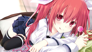 1girl black_thighhighs blue_skirt candy date_a_live food hair_between_eyes hair_ribbon indoors itsuka_kotori iwashi_dorobou_-r- lollipop long_hair long_sleeves looking_at_viewer on_bed pillow pleated_skirt red_eyes red_hair ribbon shirt skirt smile solo thighhighs twintails white_ribbon white_shirt