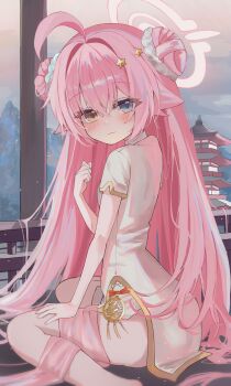 1girl absurdres blue_archive blue_eyes blush breasts chii_(k_ung) china_dress chinese_clothes double_bun dress hair_bun halo heterochromia highres hoshino_(blue_archive) long_hair looking_at_viewer outdoors pink_hair short_sleeves side_slit sitting small_breasts solo wariza yellow_eyes