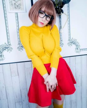 1girl breasts brown_eyes brown_hair cosplay female_focus glasses highres large_breasts looking_at_viewer medium_hair model photo_(medium) scooby-doo shibuya_kaho solo velma_dinkley velma_dinkley_(cosplay) wig