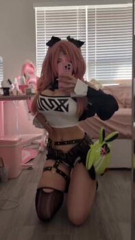 1girl animated audible_music bed bedroom breasts cellphone cleavage cosplay iphone kneeling korean_(nationality) large_breasts midriff mole mole_on_breast narrow_waist nicole_demara nicole_demara_(cosplay) phone pink_hair real_life short_shorts shorts smartphone sound suakirin tagme v video zenless_zone_zero