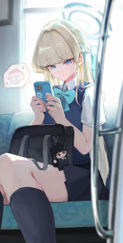 1girl absurdres bag bag_charm black_hair black_skirt blonde_hair blue_archive blue_bow blue_eyes blue_halo bow bowtie breasts cellphone character_charm charm_(object) chibigurumi collared_shirt halo highres holding holding_phone koyuuuuuuuuuuu long_hair phone pleated_skirt red_eyes rio_(blue_archive) school_uniform shirt short_sleeves sitting skirt smartphone solo subway sweater_vest toki_(blue_archive) toki_(school_uniform)_(blue_archive) white_shirt