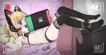 1girl animal_ear_headphones animal_ears bikini black_bikini black_thighhighs blonde_hair blue_archive blush bow butt_plug cat_ear_headphones cat_ears fake_animal_ears feet flat_chest full_body hair_bow handheld_game_console headphones highres holding holding_handheld_game_console loli lying momoi_(blue_archive) navel no_shoes on_back open_mouth pink_eyes recording sex_toy shintikku smile solo swimsuit thighhighs viewfinder voyeur_pov voyeurism