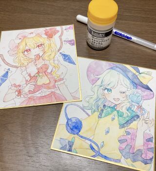 Rule 34 | 2girls, art tools in frame, ascot, black hat, blonde hair, blush, candy, commentary request, crystal, crystal wings, eating, eyeball, flandre scarlet, food, frilled shirt collar, frilled sleeves, frills, green eyes, green hair, hat, hat ribbon, highres, holding, holding candy, holding food, holding lollipop, komeiji koishi, lollipop, long sleeves, looking at viewer, mob cap, mozukuzu (manukedori), multicolored wings, multiple girls, one eye closed, one side up, open mouth, photo (medium), red eyes, red skirt, red vest, ribbon, shikishi, shirt, skirt, skirt set, smile, third eye, touhou, traditional media, vest, white hat, wide sleeves, wings, yellow ascot, yellow ribbon, yellow shirt