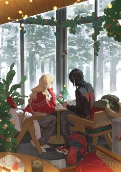 2girls backpack bag black_hair black_pants black_shirt blonde_hair brown_footwear chair christmas christmas_tree christmas_wreath coat commentary cup english_commentary garland_(decoration) green_coat head_rest highres holding holding_menu long_hair long_sleeves menu mug multiple_girls on_chair pants qiu_tong red_footwear red_sweater shirt shoes sitting sneakers sq_(series) suitcase sun_jing sweater table tanjiu unworn_coat white_coat wreath
