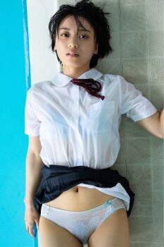 1girl black_hair clothes_lift flat_chest from_above highres japanese_(nationality) looking_at_viewer lying monami_suzu navel on_back on_floor photo_(medium) pool poolside school_uniform short_hair skirt skirt_lift wet wet_clothes