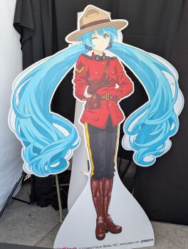 1girl absurdres arm_behind_back artist_request belt belt_buckle belt_pouch between_breasts blue_eyes blue_hair boots breasts brown_boots brown_hat buckle cardboard_cutout character_name closed_mouth coat copyright_name dot_nose floating_hair full_body hair_between_eyes hair_ornament hat hatsune_miku highres knee_boots long_hair looking_at_viewer messy_hair military_rank_insignia official_art one_eye_closed outdoors outstretched_hand photo_(medium) police pouch red_coat royal_canadian_mounted_police single_vertical_stripe small_breasts smile solo standing strap_between_breasts third-party_source very_long_hair vocaloid