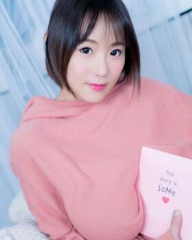 1girl book breasts brown_eyes brown_hair female_focus highres large_breasts looking_at_viewer medium_hair model photo_(medium) shibuya_kaho solo