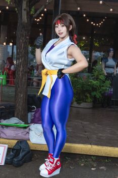 1girl black_gloves cosplay cosplay_photo female_focus fingerless_gloves gloves headband highres looking_at_viewer martial_arts_belt photo_(medium) purin_cosplay real_life red_headband ryuuko_no_ken smile snk solo spandex teeth the_king_of_fighters thumbs_up yuri_sakazaki yuri_sakazaki_(cosplay)