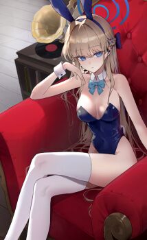1girl animal_ears blonde_hair blue_archive blue_bow blue_bowtie blue_eyes blue_halo blue_leotard bow bowtie crossed_legs detached_collar fake_animal_ears feet_out_of_frame gamgyul hair_bow halo highres legs leotard long_hair official_alternate_costume phonograph playboy_bunny rabbit_ears sitting solo thighhighs throne toki_(blue_archive) toki_(bunny)_(blue_archive) white_thighhighs wrist_cuffs