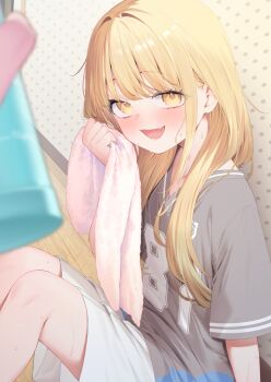 1girl :d blonde_hair collarbone commentary_request fang flat_chest fujita_kotone gakuen_idolmaster grey_shirt highres idolmaster long_hair looking_at_viewer on_floor open_mouth revision shirt short_sleeves shorts sitting skin_fang smile solo solo_focus tofu1601 towel white_shorts wooden_floor yellow_eyes