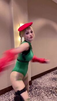 1girl animated ass bare_shoulders blonde_hair boots braid breasts cammy_white cammy_white_(cosplay) cosplay fingerless_gloves gloves green_leotard hat highleg highleg_leotard kicking leotard long_hair looking_at_viewer real_life rosewater sleeveless sound street_fighter tagme thigh_strap video