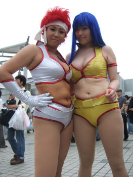 2girls belt blue_eyes breasts cleavage cosplay_photo crop_top dark_skin dirty_pair headband kei_(dirty_pair) kei_(dirty_pair)_(cosplay) long_hair multiple_girls navel outdoors photo_(medium) plump real_life red_hair short_hair short_shorts shorts yuri_(dirty_pair) yuri_(dirty_pair)_(cosplay)