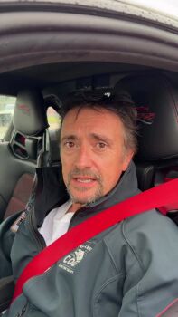 1boy 1girl animated azur_lane black_hair car jacket long_hair looking_at_viewer motor_vehicle official_alternate_costume open_clothes open_jacket porsche porsche_911 porsche_911_gt3rs real_life red_eyes richard_hammond sunglasses_on_head tagme taihou_(azur_lane) taihou_(enraptured_companion)_(azur_lane) very_long_hair video