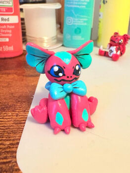 black_eyes blue_sclera claws colored_sclera cptcinnabun digimon digimon_(creature) elizamon ribbon sitting smile tail