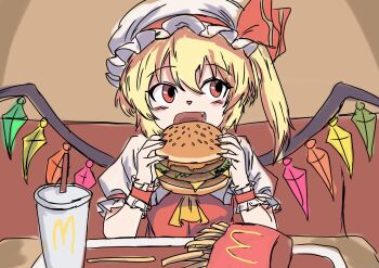 1girl blonde_hair burger crystal_wings cup disposable_cup eating fang flandre_scarlet food french_fries hat hat_ribbon highres holding holding_burger holding_food indoors kametoyou light_blush looking_to_the_side mcdonald&#039;s medium_hair mob_cap one_side_up open_mouth red_eyes red_ribbon ribbon smile solo touhou wings