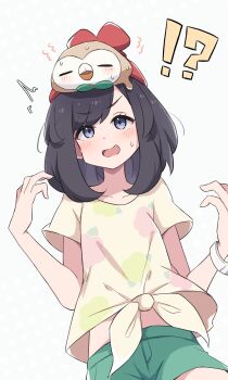 !? 1girl ^^^ absurdres beanie black_hair blush collarbone commentary floral_print gen_7_pokemon green_shorts grey_eyes hands_up hat highres medium_hair midriff nintendo on_head open_mouth piyo_to_game pokemon pokemon_(creature) pokemon_on_head pokemon_sm red_hat rowlet selene_(pokemon) shirt short_sleeves shorts simple_background sweatdrop tied_shirt white_background yellow_shirt