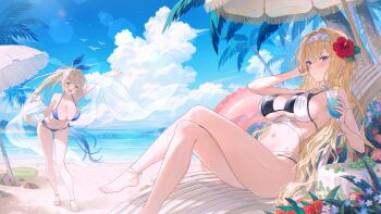 2girls :d anklet arm_up bare_shoulders barefoot beach bikini black_bikini blonde_hair blue_bikini blue_eyes blush breasts cleavage closed_mouth crossed_legs day flower foot_out_of_frame fymrie hair_flower hair_ornament highres holding jewelry large_breasts long_hair looking_at_viewer multiple_girls navel ocean open_mouth original outdoors parasol ponytail side-tie_bikini_bottom sitting smile standing stomach swimsuit thighs umbrella underboob water yellow_eyes