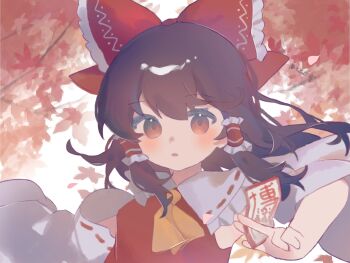 1girl autumn_leaves bow brown_hair detached_sleeves dress frills gohei hair_ribbon hakurei_reimu highres large_bow leaf long_hair maple_leaf misakiii necktie ofuda red_dress redrawn ribbon solo touhou yellow_necktie