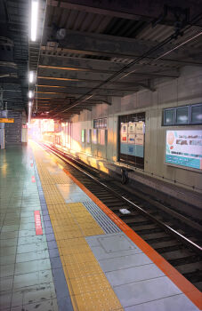 Rule 34 | absurdres, commentary request, concrete, evening, highres, indoors, karasu (hageabura-jr), no humans, original, realistic, scenery, shadow, sign, stairs, sunlight, tactile paving, tile floor, tiles, track ballast, train station, train station platform