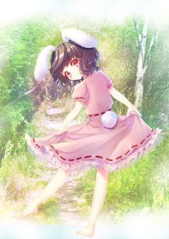 1girl animal_ears bare_arms bare_legs barefoot black_hair blush carrot_necklace commentary dress frilled_sleeves frills highres inaba_tewi jewelry looking_at_viewer looking_back lop_rabbit_ears miki-cacao necklace outdoors photo_background pink_dress rabbit_ears rabbit_girl rabbit_tail red_eyes short_hair short_sleeves skirt_hold smile solo tail touhou