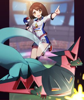 1girl :d brown_eyes brown_hair collared_shirt commentary dragapult fourth_wall gen_8_pokemon gloria_(pokemon) gloves grey_shirt grey_shorts grey_socks gym_challenge_uniform highres holding holding_poke_ball jumping kneehighs lens_flare long_sleeves looking_at_viewer nintendo open_mouth pillarboxed pointing poke_ball poke_ball_(basic) pokemon pokemon_(creature) pokemon_swsh print_shirt red_footwear senta_(ysk_0218) shirt shoes short_hair short_shorts shorts single_glove smile sneakers socks stadium standing striped_clothes striped_shirt vertical-striped_clothes vertical-striped_shirt