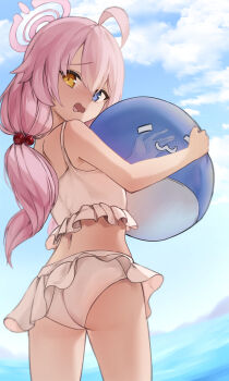 1girl absurdres ahoge ass back bikini blue_archive blue_eyes blue_sky blush commentary cowboy_shot day embarrassed frilled_bikini frills from_behind furrowed_brow hair_bobbles hair_ornament halo heterochromia highres holding holding_toy hoshino_(blue_archive) hoshino_(swimsuit)_(blue_archive) inflatable_toy inflatable_whale long_hair looking_at_viewer looking_back low_twintails midriff no_eyewear nose_blush ocean odod1228 official_alternate_costume official_alternate_hairstyle outdoors pink_hair pink_halo sky solo swimsuit toy twintails white_bikini yellow_eyes
