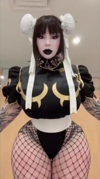 Rule 34 | 1girl, animated, bed, bedroom, bent over, bishoujomom, brown hair, capcom, chun-li (cosplay), collar, cosplay, face paint, fake nails, female focus, fishnets, goth fashion, jiggle, jiggling thighs, leggings, lipstick, long hair, looking at viewer, makeup, on bed, one eye closed, open mouth, real life, sitting, solo, sound, spiked collar, spikes, street fighter, tagme, tattoo, thick thighs, thighs, tongue, tongue out, v, video, wink