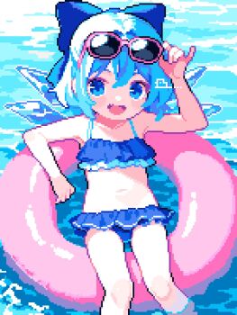 1girl :d adjusting_eyewear ahiru_tokotoko artist_logo bikini blue_bikini blue_bow blue_eyes blue_hair blush_stickers bow cirno commentary day eyewear_on_head feet_out_of_frame hair_bow highres ice ice_wings innertube logo looking_at_viewer navel ocean open_mouth outdoors pink-framed_eyewear pixel_art short_hair smile solo sunglasses swim_ring swimsuit touhou water wings