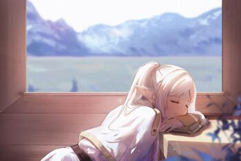 1girl belt blurry blurry_background blurry_foreground capelet chinese_commentary closed_eyes commentary day earrings elf frieren from_side heibai_bangbing highres indoors jewelry leaning_on_table lens_flare light_particles mountain mountainous_horizon pointy_ears ponytail short_eyebrows signature sleeping solo sousou_no_frieren white_capelet white_hair window