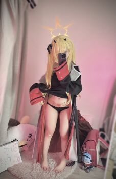 1girl backpack bag barefoot black_panties blonde_hair blue_archive cellphone chizucheese cosplay covering_face fake_horns feet from_front full_body hair_ornament halo hat highres horns ibuki_(blue_archive) lifting_own_clothes loli long_hair long_sleeves mirror_selfie navel navel_piercing panties peroro_(blue_archive) petite phone photo_(medium) piercing pubic_tattoo randoseru real_life selfie smartphone solo standing tattoo underwear